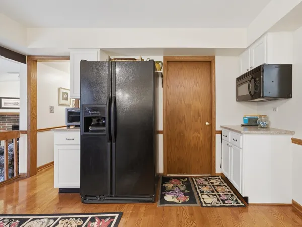 a kitchen with stainless steel appliances granite countertop a refrigerator and a stove
