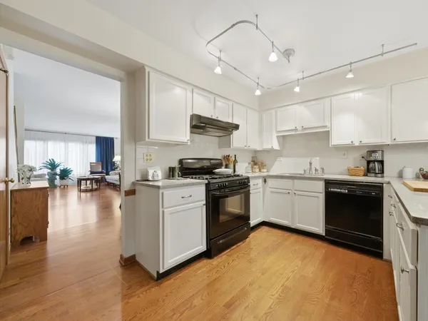 a kitchen with a stove a sink and a refrigerator