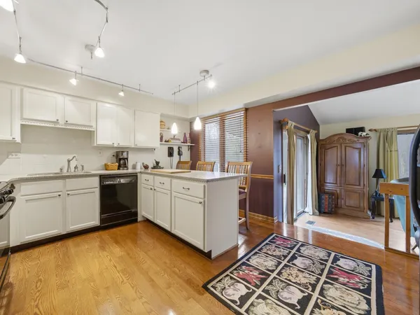 a kitchen with a refrigerator and white cabinets