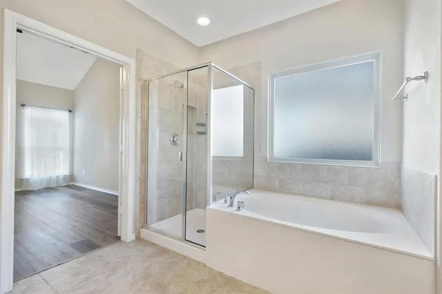 a bathroom with a bathtub and a shower