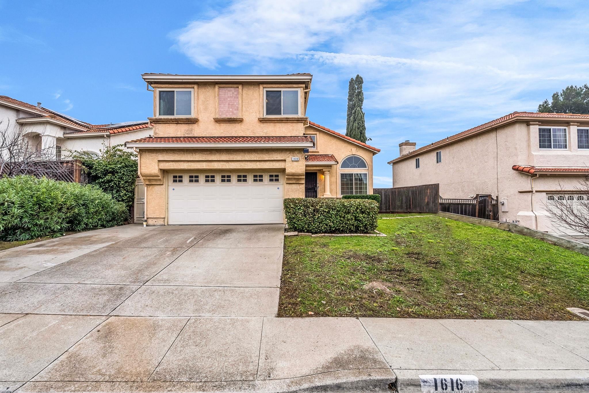 1616 Mellowood Street Pittsburg, CA 94565 - Photo 1 of 1 a front view of a house with a yard and garage