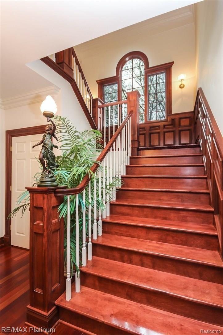 6945 Gawley Road Pinckney, MI 48169 - Photo 7 of 76 A spectacular staircase leads you to the library and bedroom level.