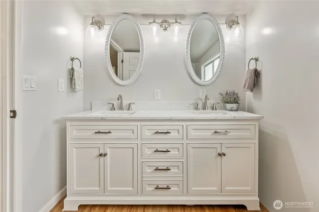 a bathroom with a double vanity sink and a mirror