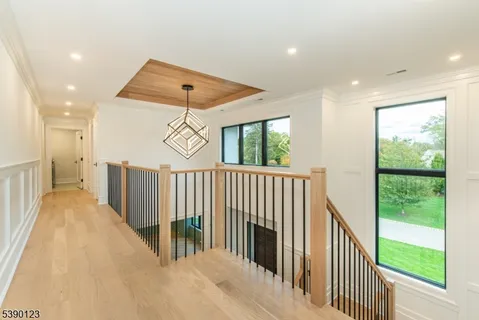 a view of a hallway with window and stairs