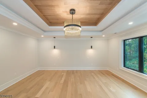 a view of a room with wooden floor and window