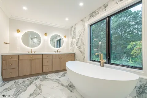 a bathroom with a bathtub and a large mirror