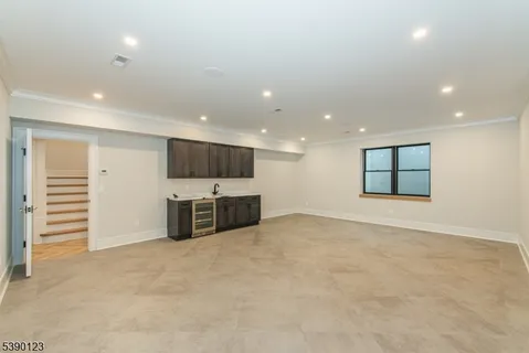 an empty room with a kitchen and a window