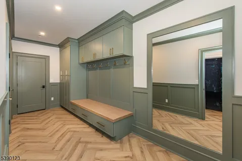 a bedroom with a bed and a large mirror