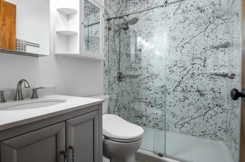 15 Lawrence Road, Unit 25 Rowley, MA 01969 - Photo 3 of 16 a bathroom with a granite countertop toilet sink and mirror