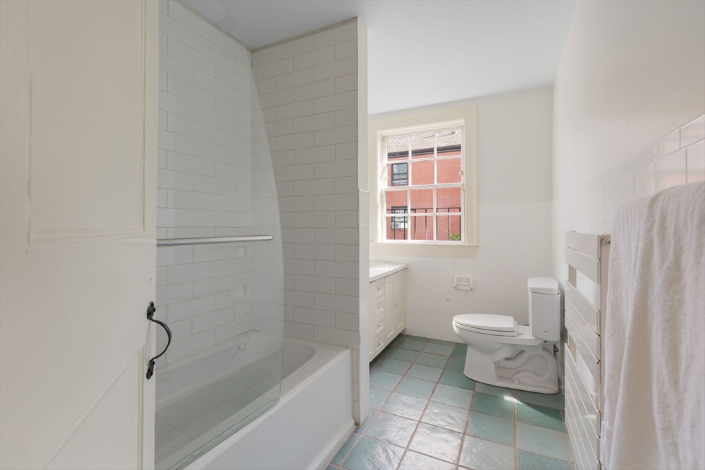 24 Fayette Street, Unit 24 Boston, MA 02116 - Photo 12 of 36 a bathroom with a toilet a sink and a bathtub