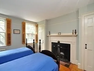 a bedroom with a bed and a fireplace