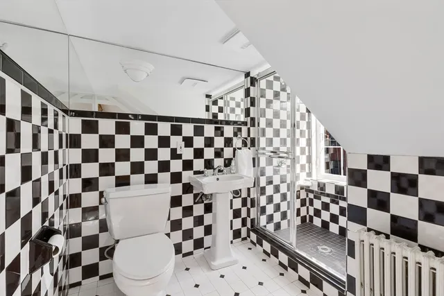a bathroom with a black and white checkered floor