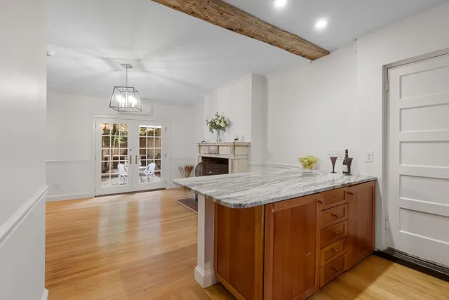 a spacious bathroom with a granite countertop sink a toilet a mirror and shower