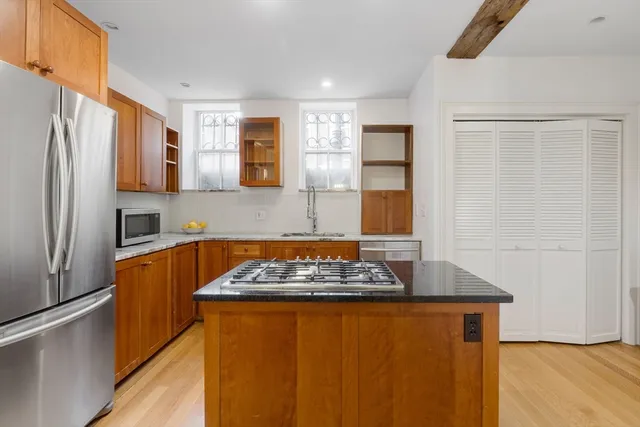 a kitchen with stainless steel appliances granite countertop a refrigerator and a stove