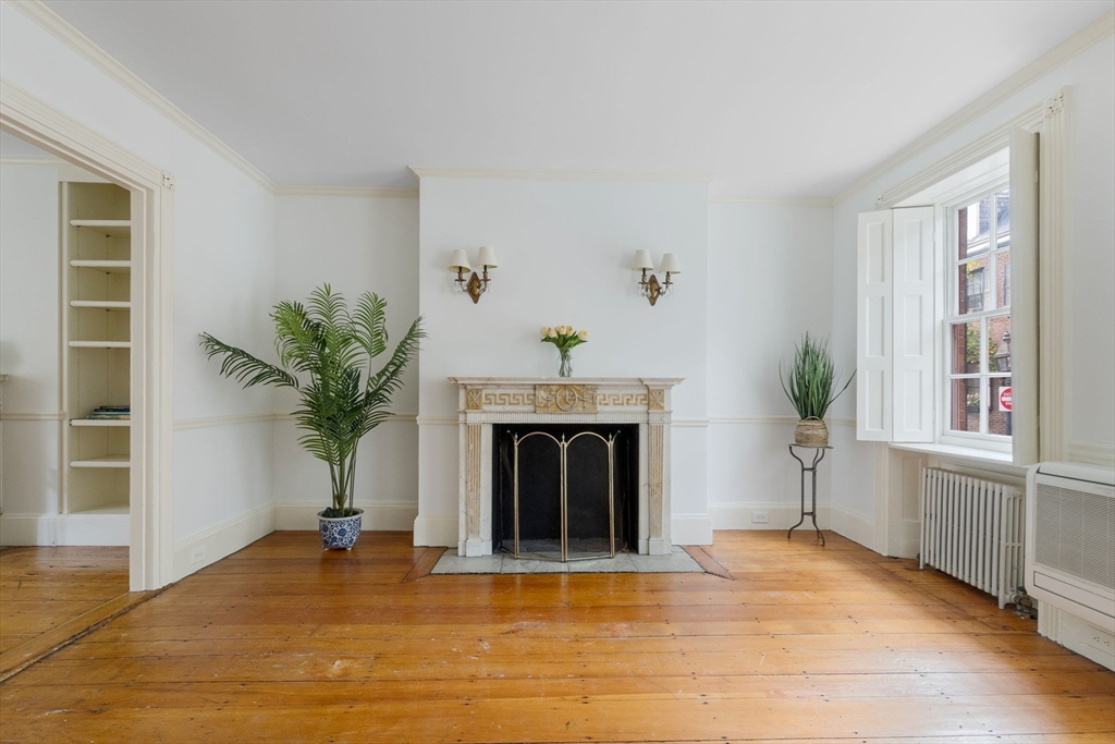 24 Fayette Street, Unit 24 Boston, MA 02116 - Photo 5 of 36 a living room with a fireplace and potted plant