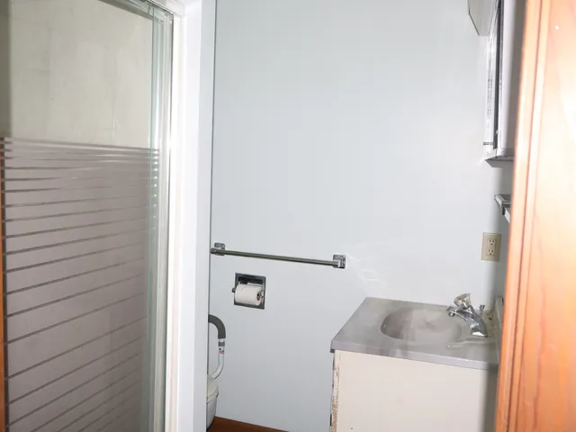 a bathroom with a granite countertop sink and vanity