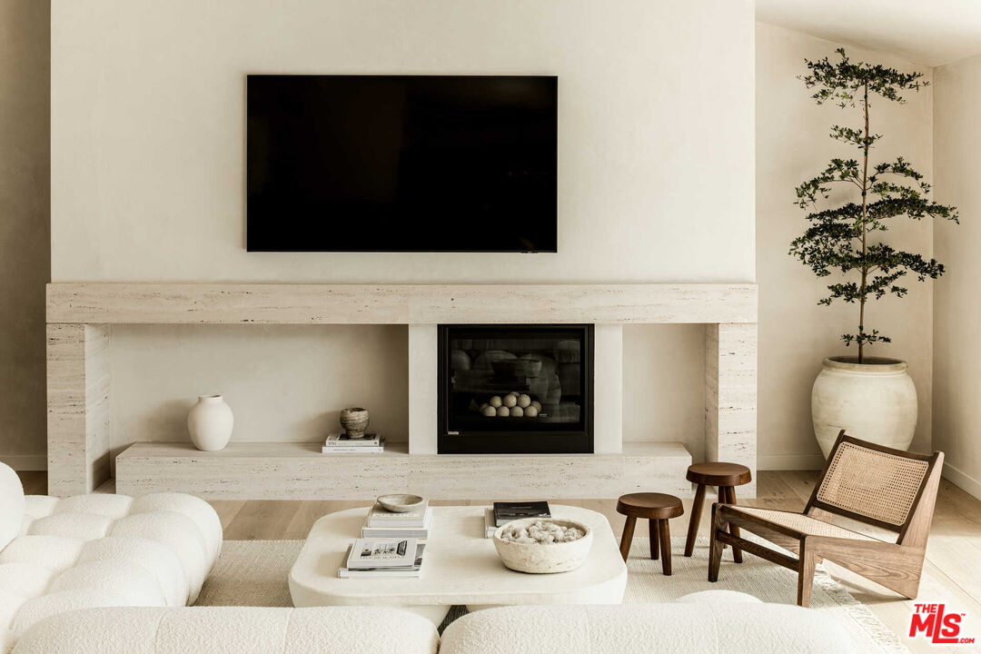 1718 Rising Glen Road Los Angeles, CA 90069 - Photo 3 of 19 a living room with furniture and a fireplace