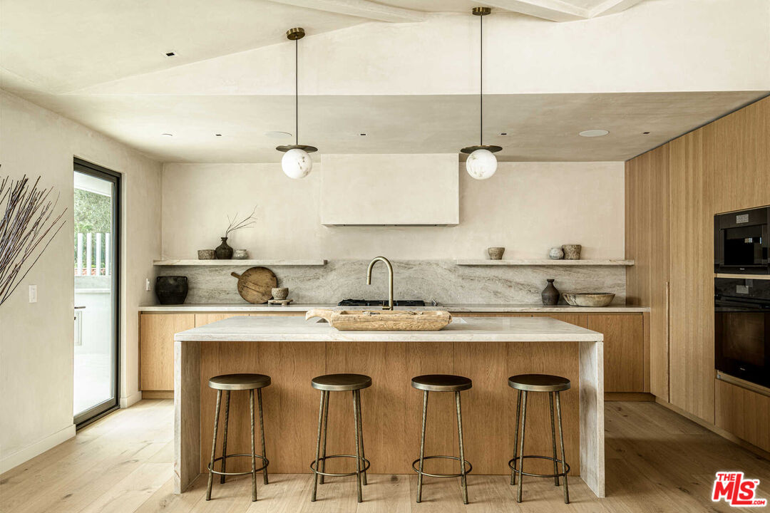 1718 Rising Glen Road Los Angeles, CA 90069 - Photo 4 of 19 a kitchen with a center island and cabinets