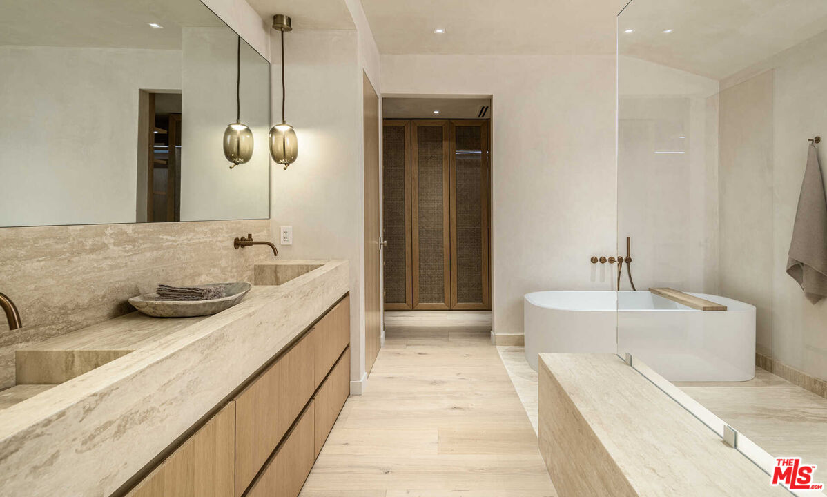 1718 Rising Glen Road Los Angeles, CA 90069 - Photo 9 of 19 a spacious bathroom with a granite countertop sink and a bathtub