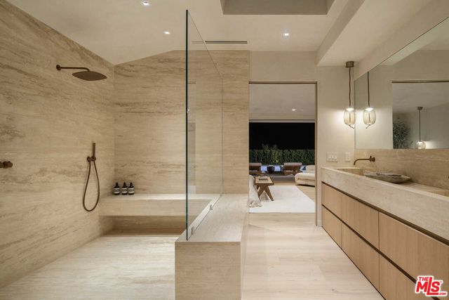 a view of a bathroom with bathtub and shower