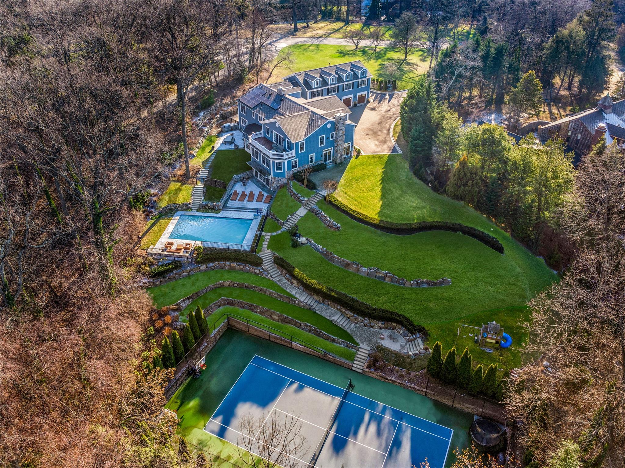 an aerial view of a house with a yard and swimming pool