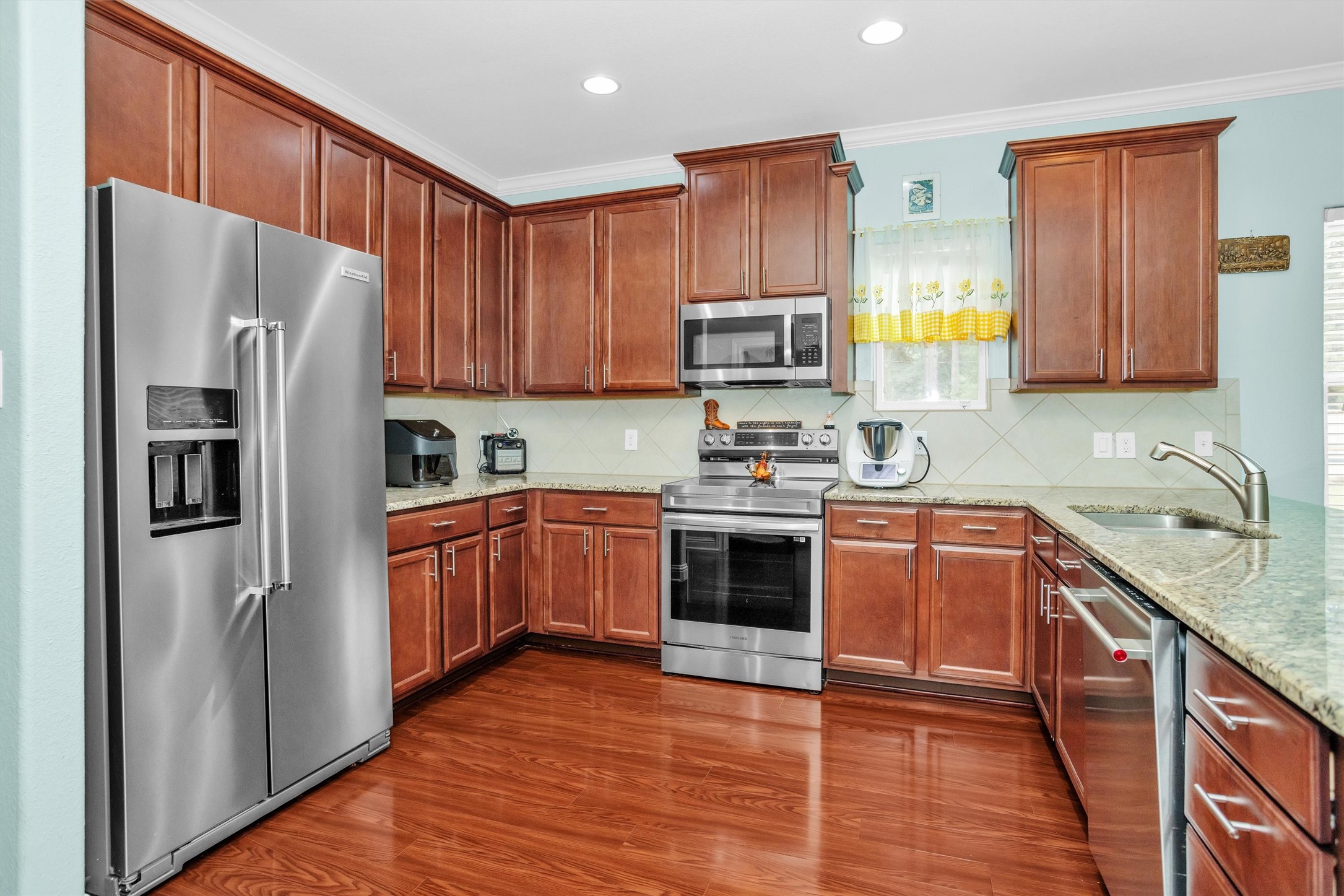 30806 Mellman Road Hempstead, TX 77445 - Photo 10 of 35 There is a lot of granite countertop space and solid wood cabinets. A small rolling island should just fit for the entertaining prep work. The new flooring extends through the house and is easy to clean.