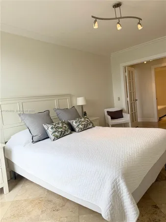 a bedroom with a bed and ceiling fan