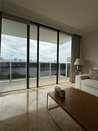 a bedroom with furniture and large windows