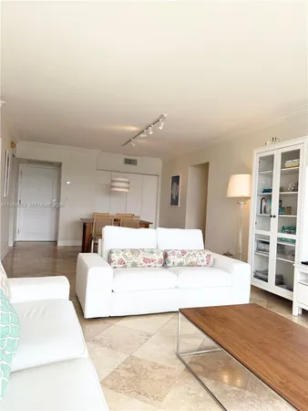 a large white bed in a white room