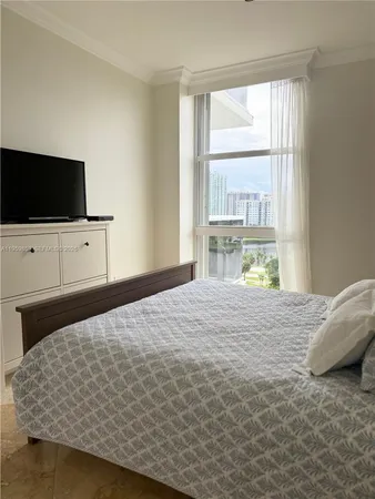 a bedroom with a bed and flat screen tv