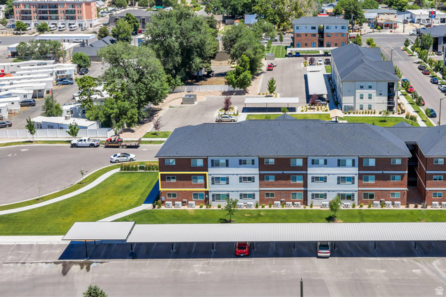 572 South 100 West, Unit E210 Springville, UT 84663 - Photo 7 of 35 Multi-story building featuring a dark gray shingle roof and a brick facade with light gray siding accents
