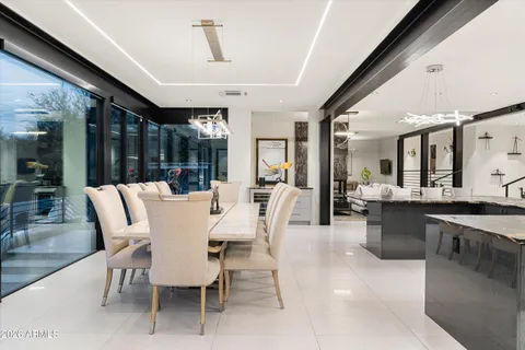 a bedroom with a bed a large window and flat screen tv