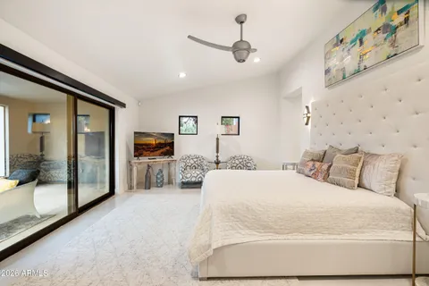 a bedroom with a bed lamp and a window