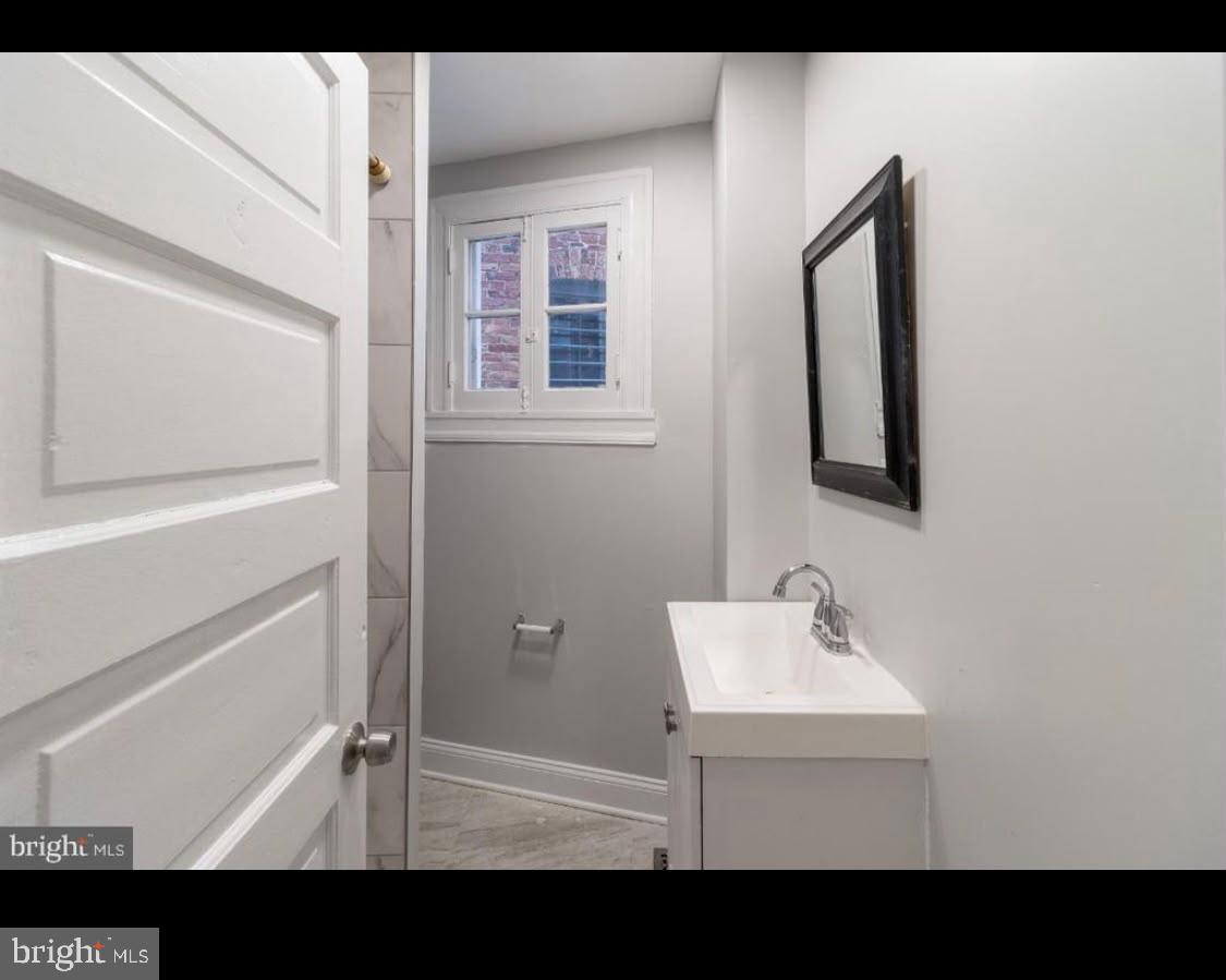 1626 Appleton Street Baltimore, MD 21217 - Photo 13 of 18 a bathroom with a sink mirror and vanity