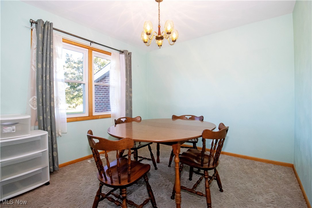 1675 South Funk Road Wooster, OH 44691 - Photo 7 of 34 Carpeted dining space with a notable chandelier