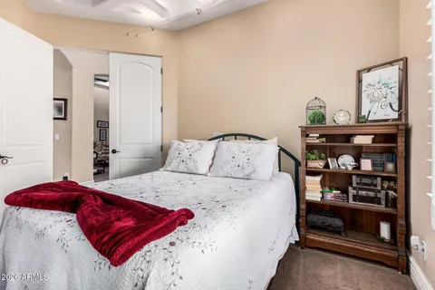 a bed sitting in a bedroom next to a window