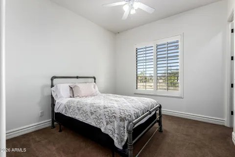 a view of a house with pool table and chairs under an umbrella