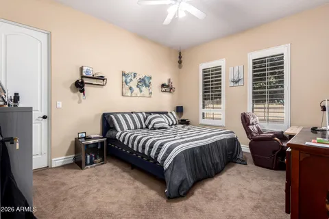 a living room with furniture a fireplace and a floor to ceiling window