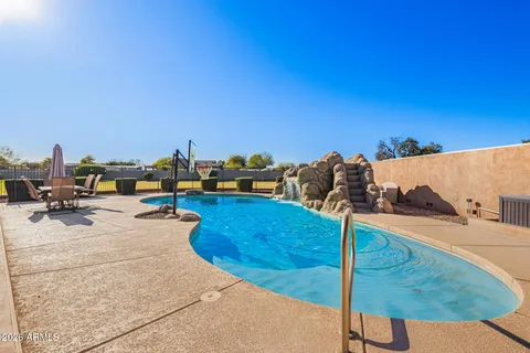 a view of a swimming pool with a table and chairs