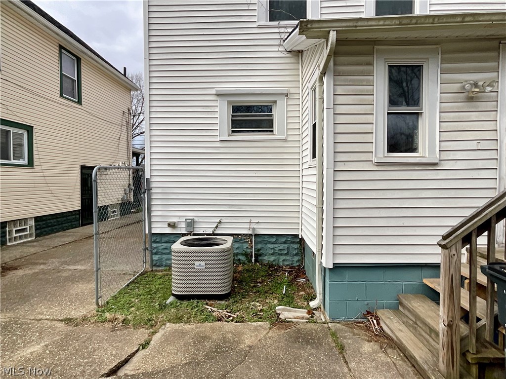 425 Spaulding Street Akron, OH 44310 - Photo 16 of 17 View of side of home with a gate and a central AC unit