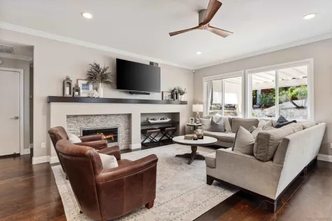 a living room with furniture a fireplace and a flat screen tv