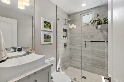 a bathroom with a sink toilet and shower