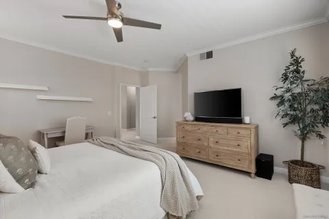 a bedroom with a bed and a flat tv screen