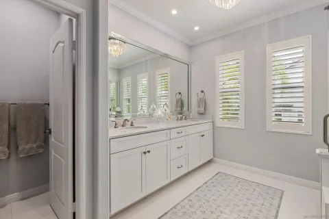 a spacious bathroom with double vanity and a mirror