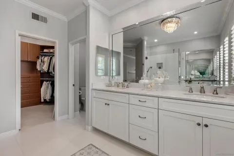 a bathroom with double sink and a mirror