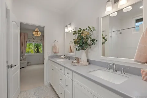 a bathroom with a granite countertop sink a large mirror and a shower