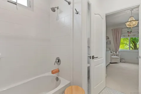 a bathroom with a tub and a shower