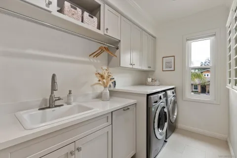 a utility room with sink dryer and washer