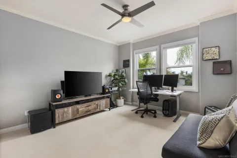 a view of a livingroom with workspace and a window