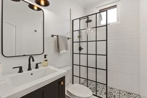 a bathroom with a sink toilet and mirror